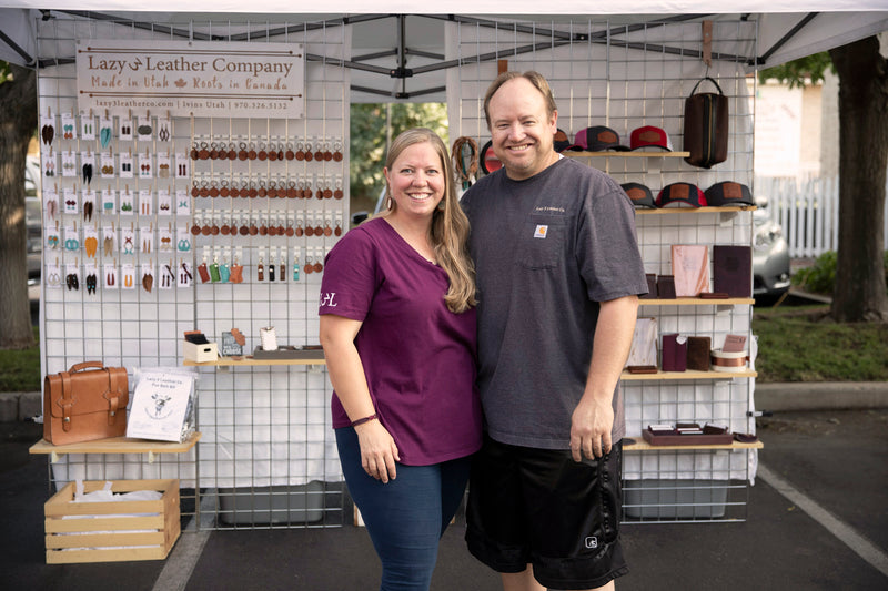 Todd and Lucy of Lazy 3 Leather Co standing in front of their booth