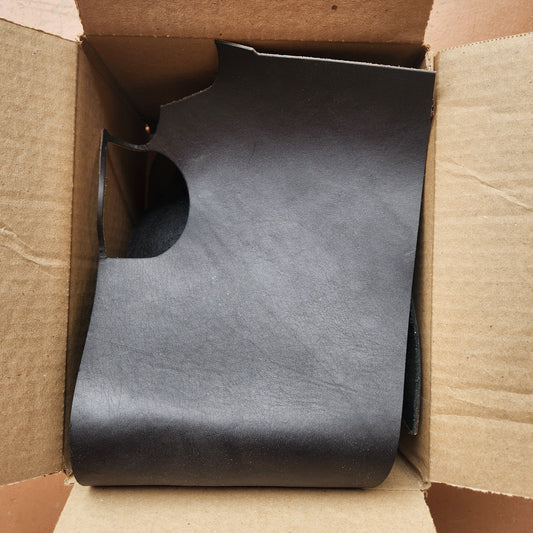 Black leather wallet inside an open cardboard box