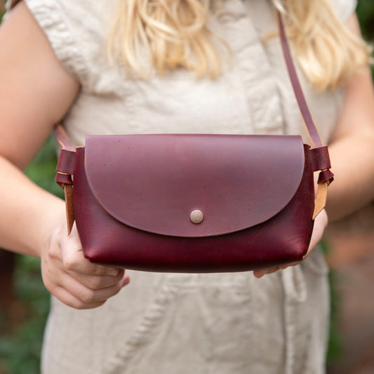 Little Jane leather crossbody purse in eggplant full grain leather front view with antique copper snap closure