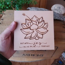 Load image into Gallery viewer, size comparison in the hand Laser engraved quote but with joy wend you way leather wall art on natural full grain veg tan leather made by Lazy 3 Leather Co.