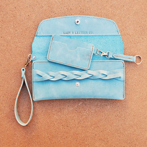 Wristlet leather clutch made by Lazy 3 Leather Co. in  Tandy Leather's Denver side in Aqua blue. with a minimal wallet with keyfob. antique brass hardward. lazy 3 leather co wallet in Tandy Denver side in Aqua.