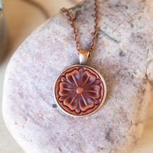 Load image into Gallery viewer, Scottish Rose stamped leather necklace mounted in antique copper pendant and has a matching chain made by lazy 3 leather co.