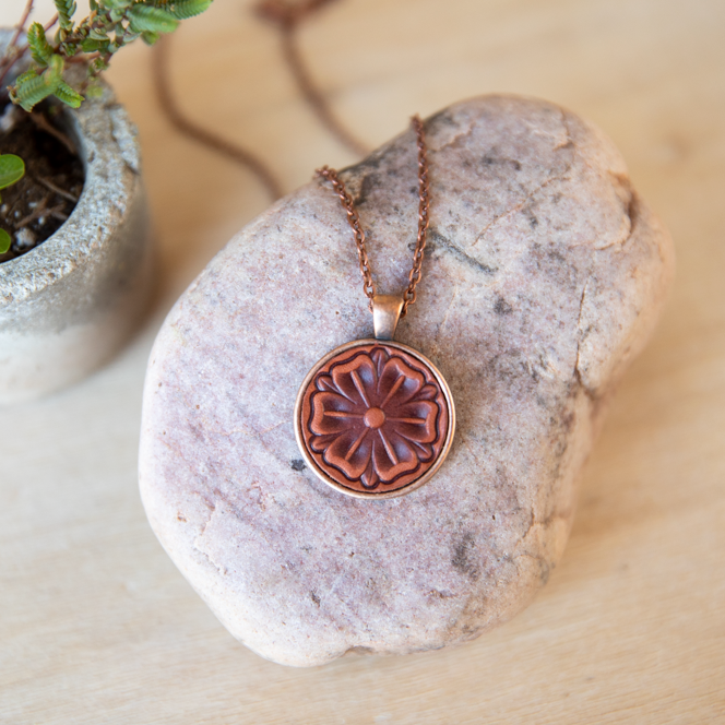 Scottish Rose stamped leather necklace mounted in antique copper pendant and has a matching chain made by lazy 3 leather co.