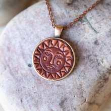 Load image into Gallery viewer, Sun and Moon stamped leather necklace mounted in antique copper pendant and has a matching chain made by lazy 3 leather co.