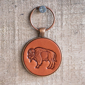 hanging leather keychain with a buffalo stamped into it